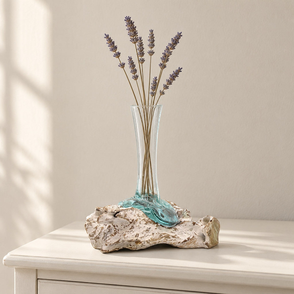 Medium molten glass vase on whitewashed wood holding dried lavender, on a painted bedside table