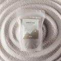 Azure Noir fragranced candle sand in warm grey