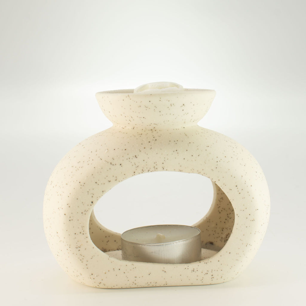 Pebble wax burner with a tealight inside and a wax melt cube in the dish