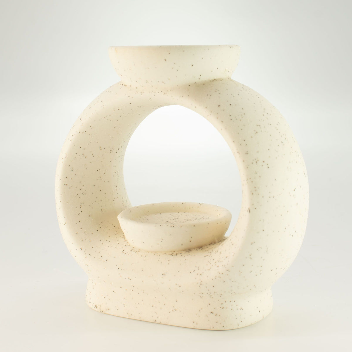 Large pebble wax burner in speckled off-white ceramic, seen from an angle