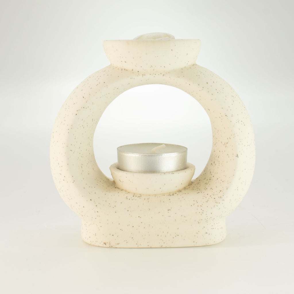 Large pebble wax burner with a tealight inside and a wax melt cube in the dish