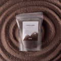 Millionaire Gold fragranced candle sand in chocolate brown
