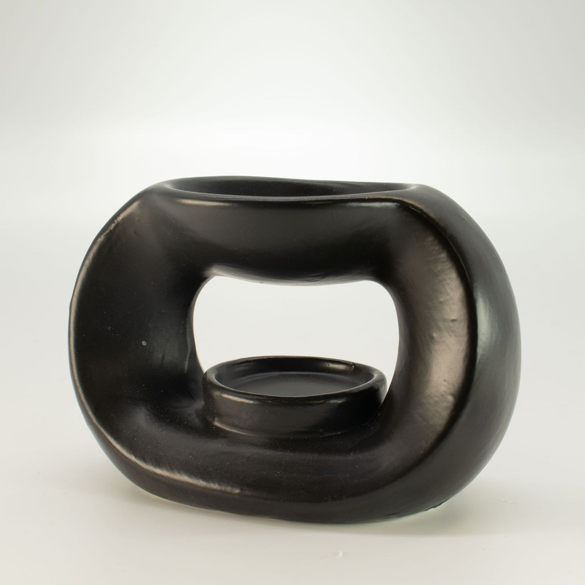 Matt black pebble wax burner, seen from an angle