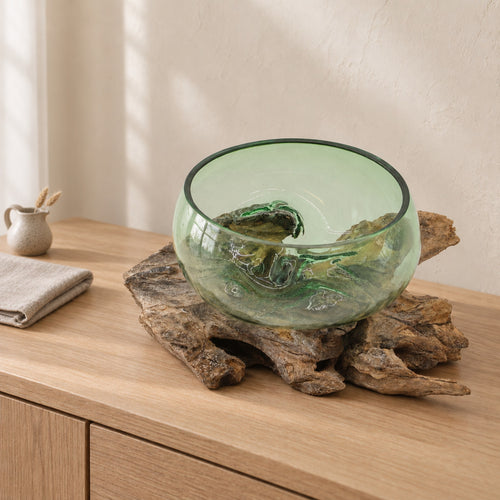 Large wide beer bottle glass bowl on wood, on a pale oak sideboard