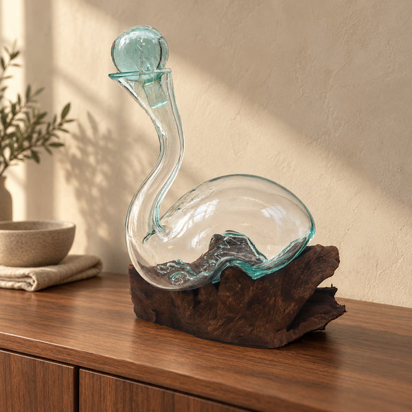 Molten glass decanter on wood with a glass stopper, on a walnut sideboard