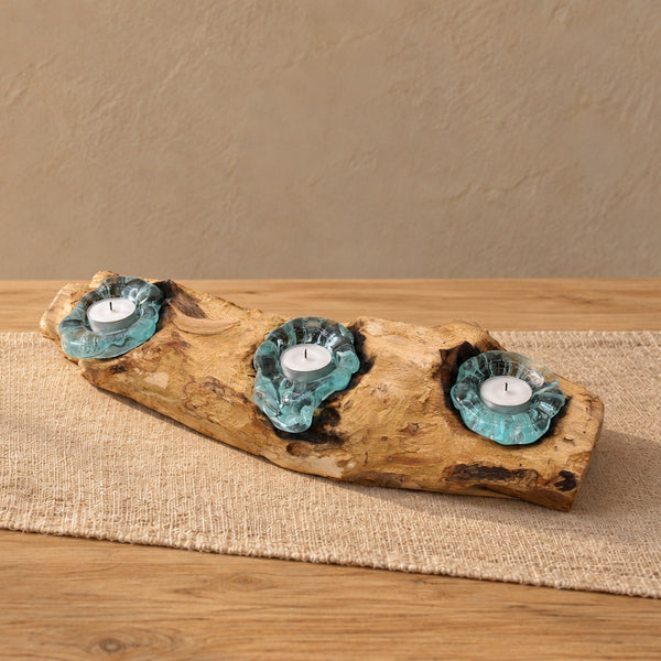 Triple molten glass candle holder on wood with three tealights, on a dining table